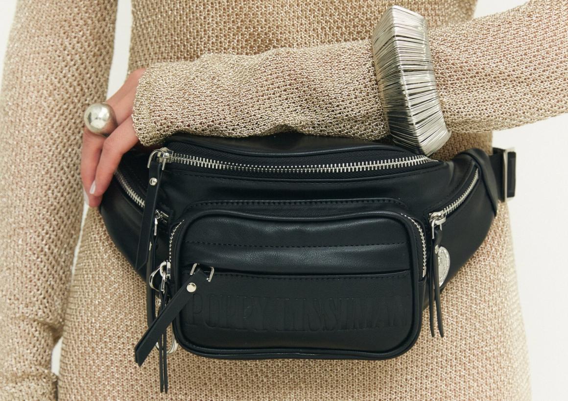 A model wearing gold, wearing a black Poppy Lissiman belt bag. One of Perth's best womenswear brands