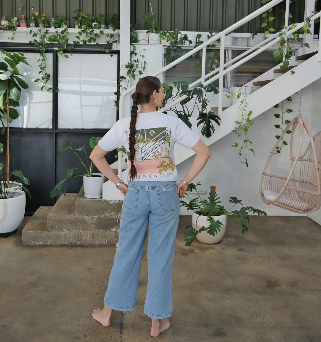 A woman wearing a Feld & Co branded t-shirt at their content studio. Perfect for social media content.