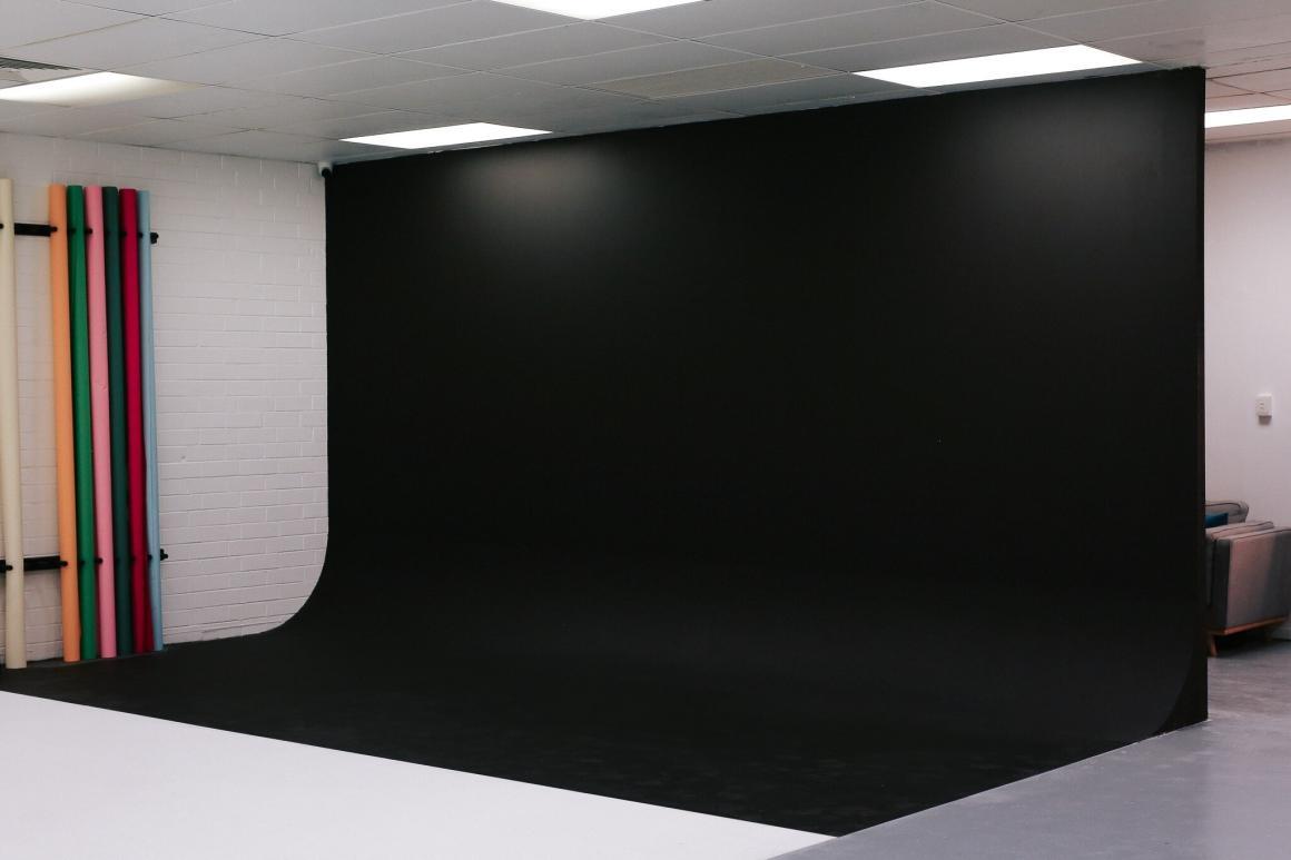 A wide shot of the inside of Flash Photo Studios, with a black background. One of Perth's best content studios for social media content.