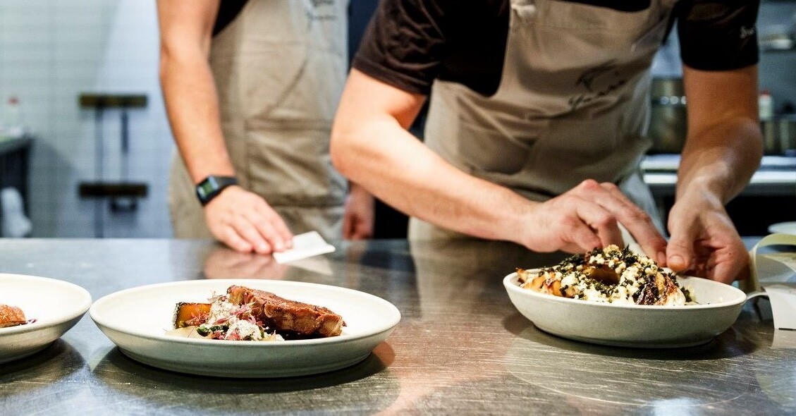 A chef making a dish in the kitchen at Yarri, a restaurant in Dunsborough