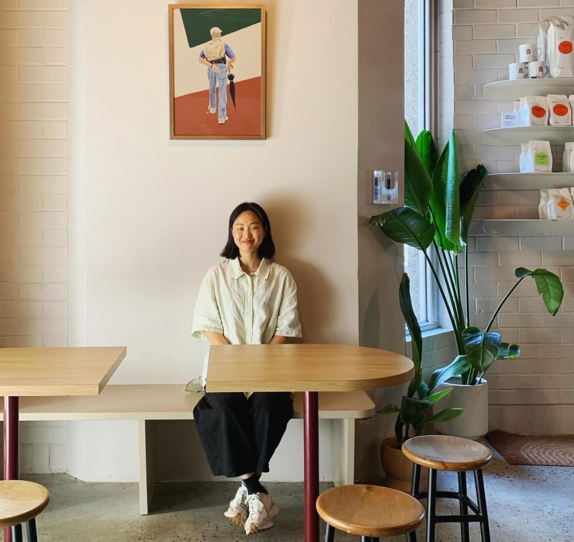 A young woman sits in Howard's Groove coffee shop in Howards Street Perth.