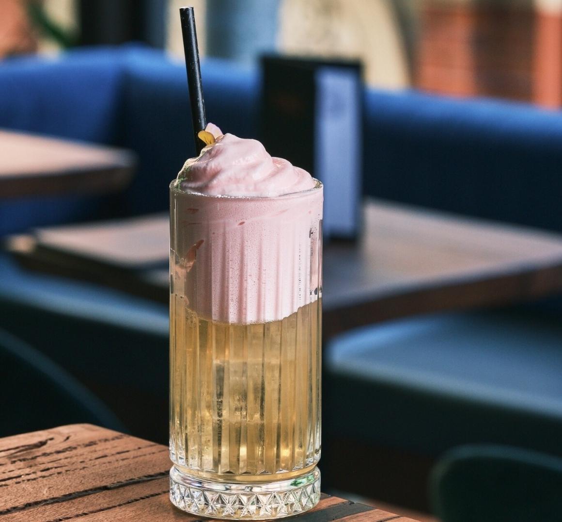 A fancy cocktail sits on a bar at Terrarium in Howard Street