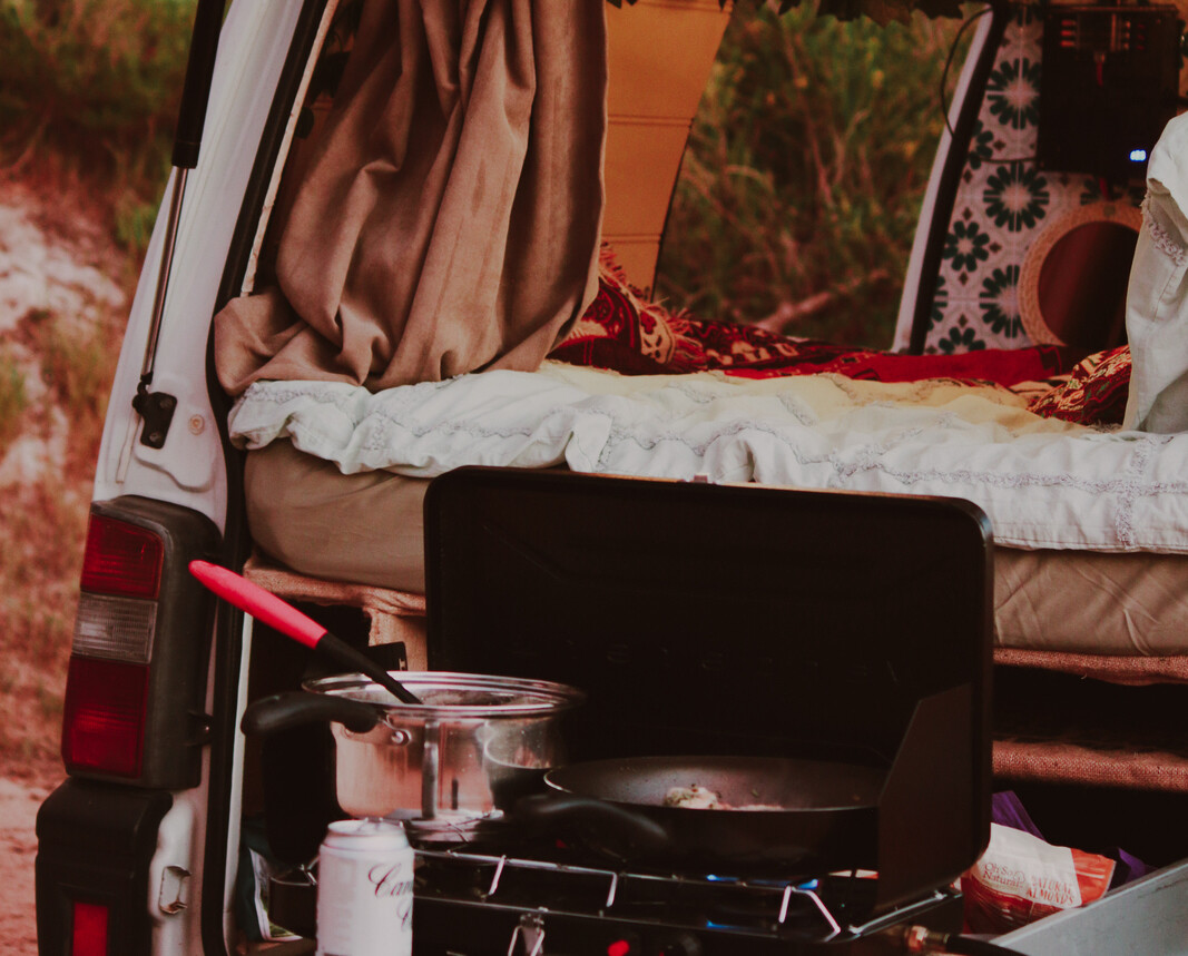 The back of Bitsy the Bishi campervan open. With cooker and bed. One of the best instaworthy campervans in WA