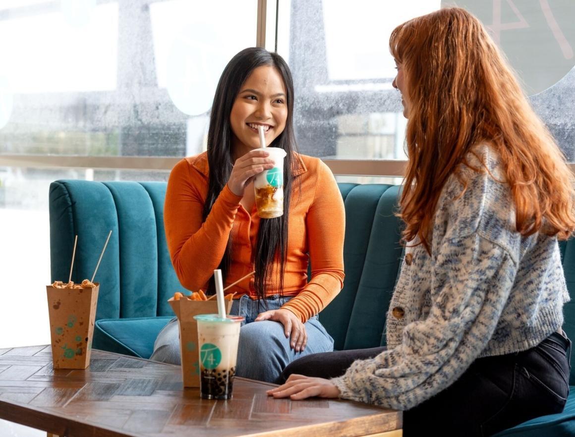 Two women enjoy bubble boba and snacks at T4 Innaloo, one of Perth's best bubble tea spots