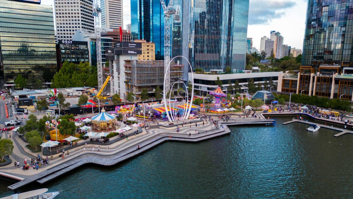 A wide angle drone shot of Elizabeth Quay with a carnival going on
