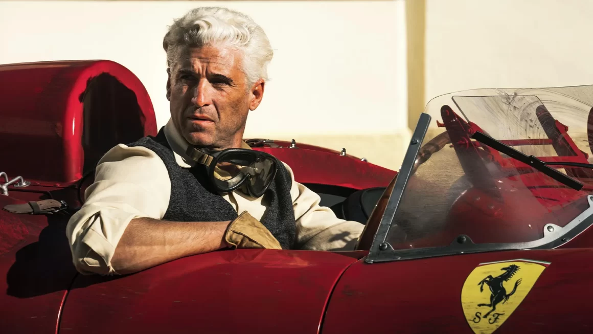 A still from the Ferrari film, featuring the main character sitting in a Ferrari car