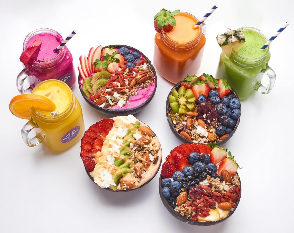 A top down image of a spread with acai bowls and smoothies at little cultures