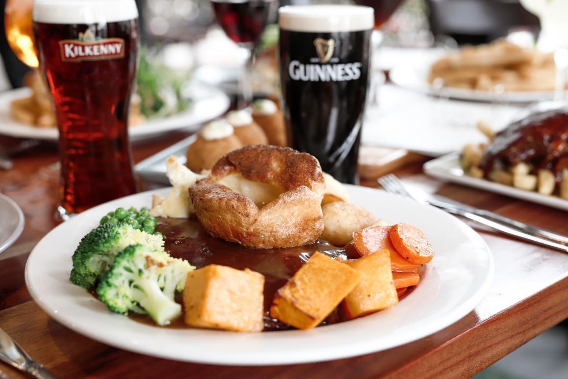 A roast dinner in front of a pint of Guinness and Kilkenny at Paddy Malone’s