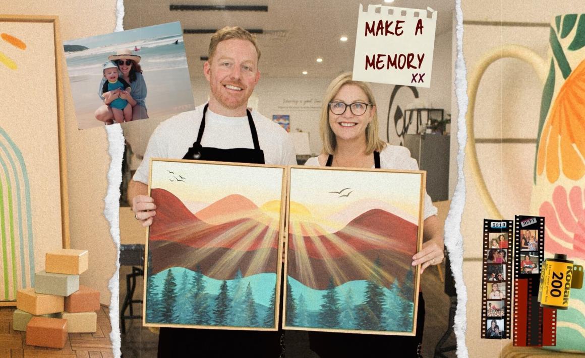 A mother and son holding up matching paintings