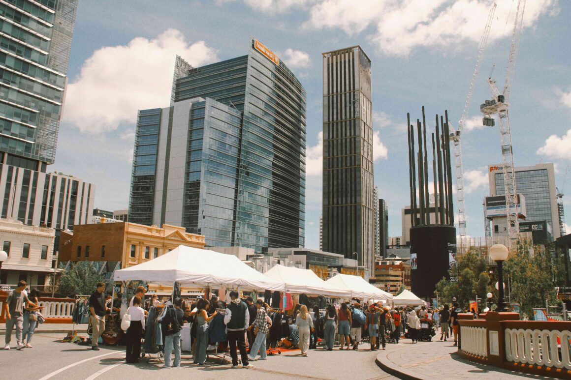 A wide shot of the Secondlife Markets in front of the city highrises 
