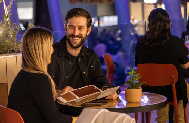 A couple sitting at a table in Stories Front Yard