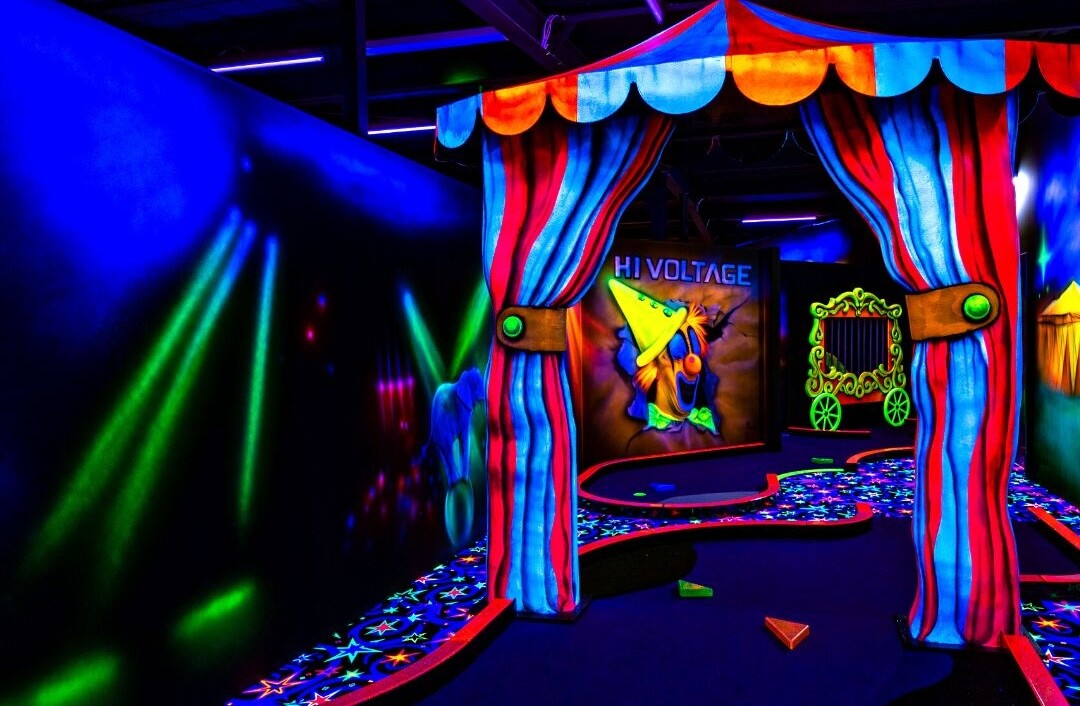 The glowing putt putt course at Hi Voltage, showing a circus tent