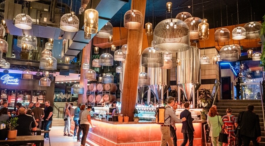 A wide shot of the Stories Pourhouse with lots of lights hanging from above