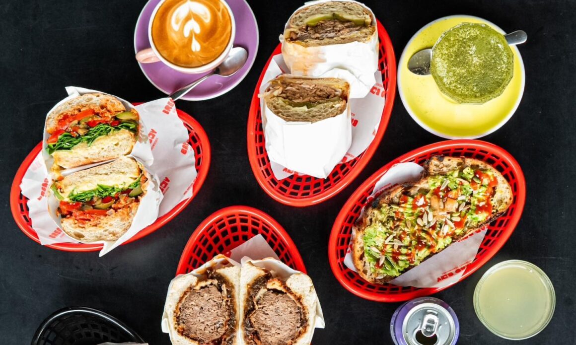 A spread of food and drinks including a matcha latte sits on a table at Breadboy in Perth
