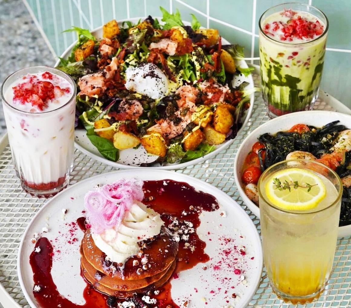 A spread of food on a table at Cafe Eighty2 including a matcha latte in Perth