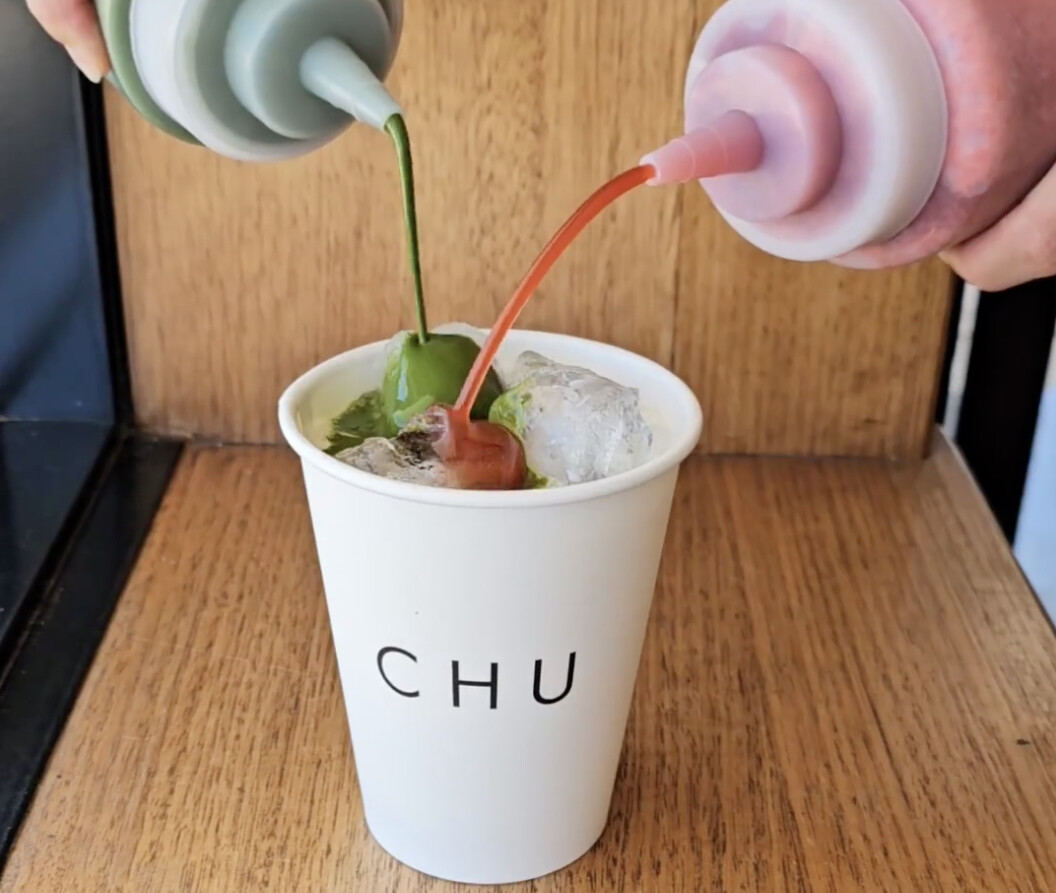 A green and pink syrup being poured into a coffee cup at Chu to make a strawberry matcha latte in Perth