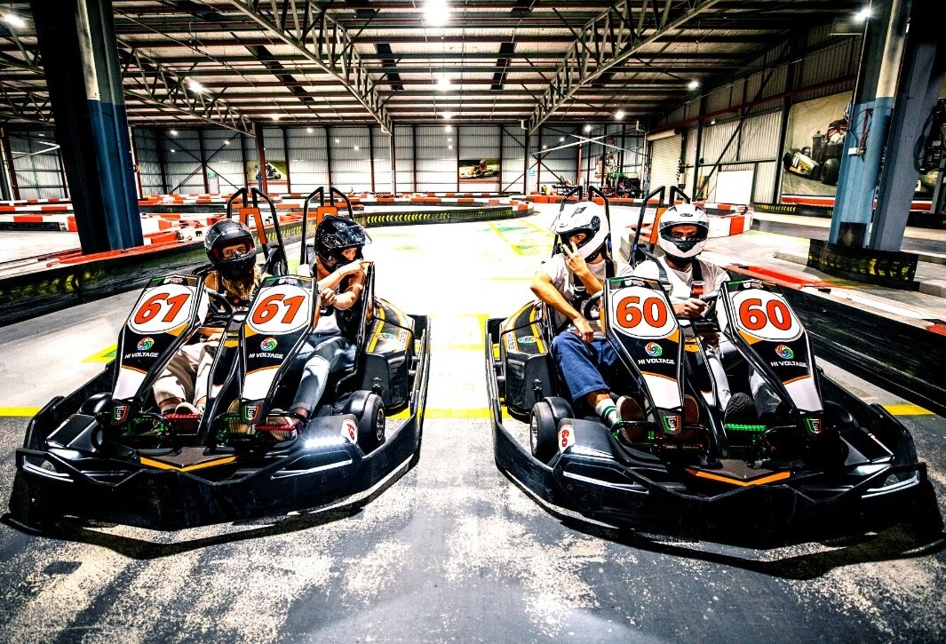 Two couples racing on dual karts at Hi Voltage go karting in Perth