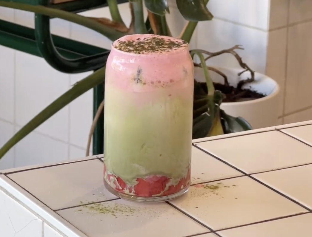 A strawberry matcha latte sits on a bench at In Good Hands in Perth