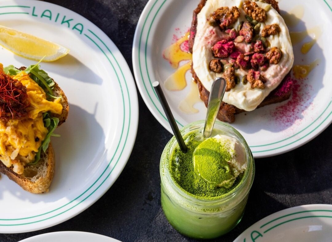 A spread of food including a matcha latte sits on a table at Laika cafe in Perth
