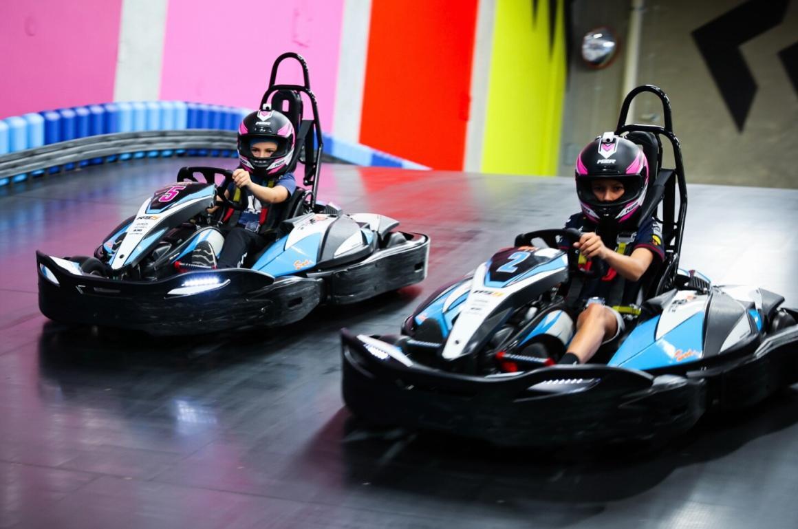 Two people racing in go karts side by side at Powerplay in Perth