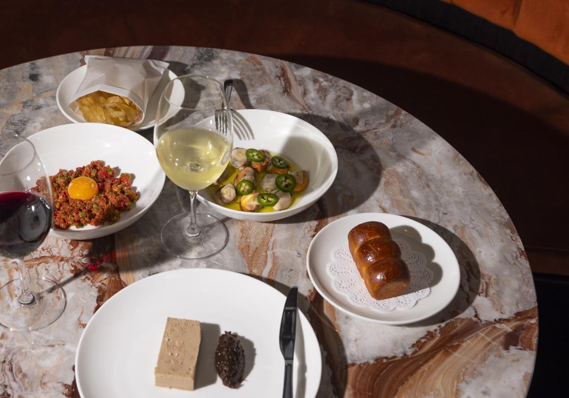 A spread of food and drinks on a stone table at Cassia restaurant in Fremantle