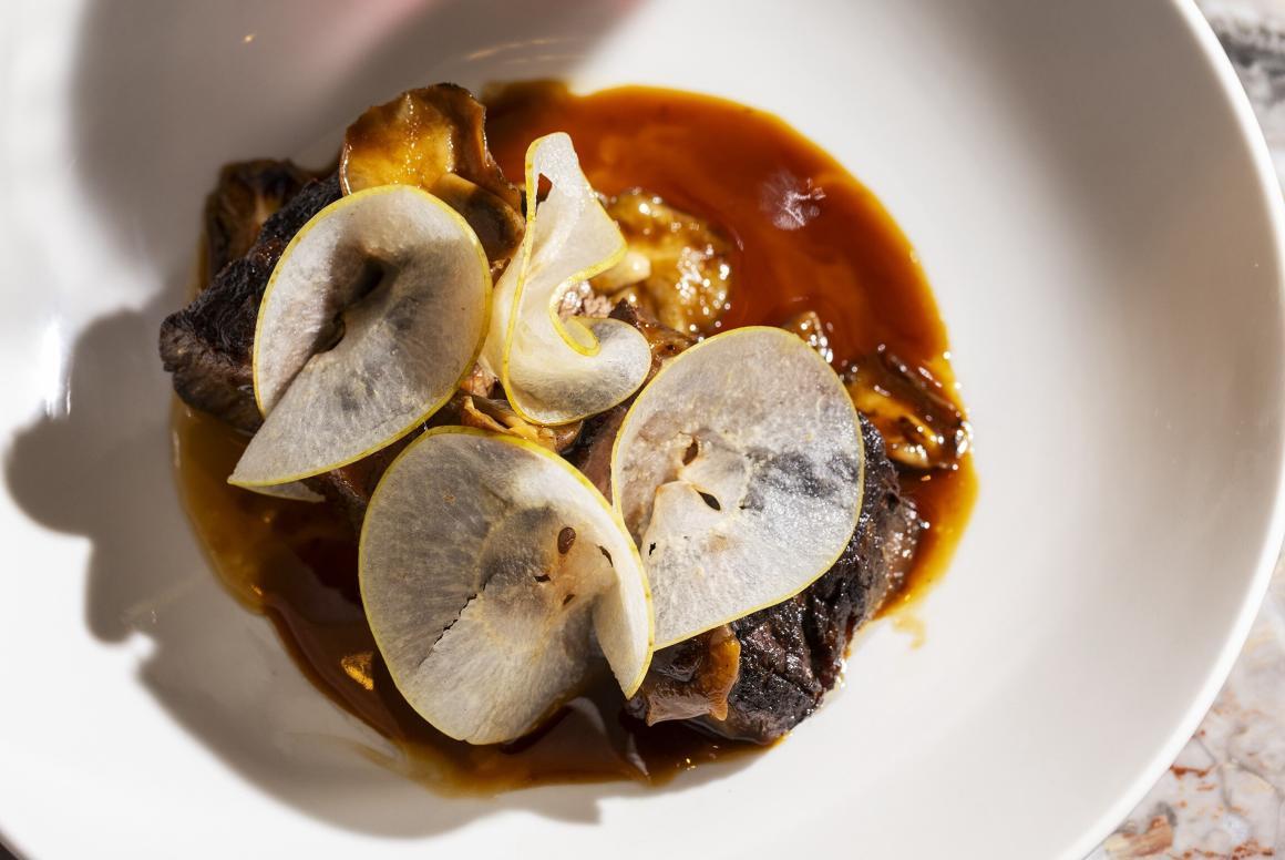 A close-up of a pear and meat dish at Cassia restaurant in Fremantle