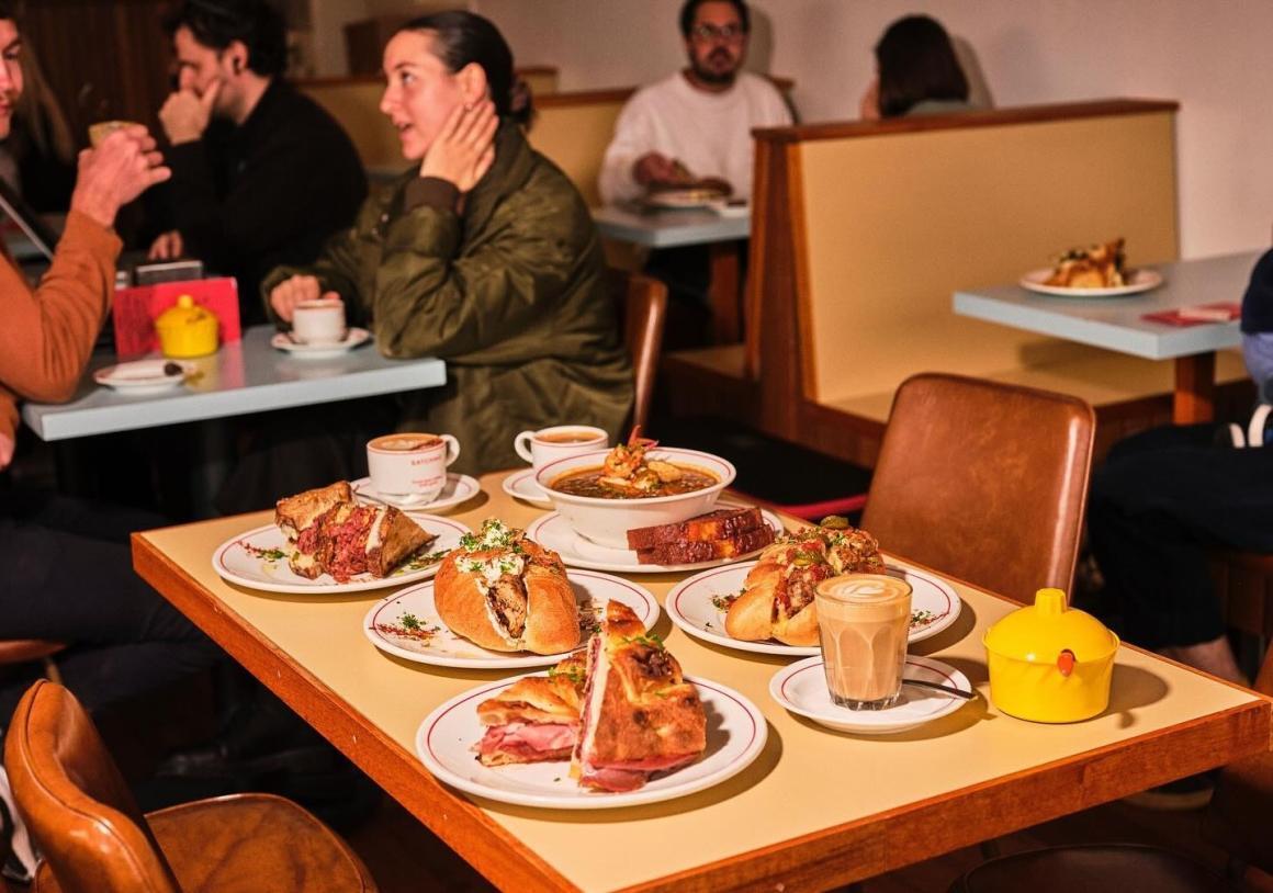 A wide shot of the inside of Satchmo, with a table full of food. One of Perth's best bagel spots