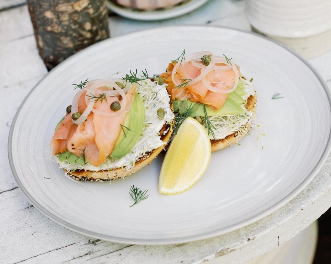 An open salmon bagel on a plate at Stomp Coffee. One of Perth's best bagel spots 