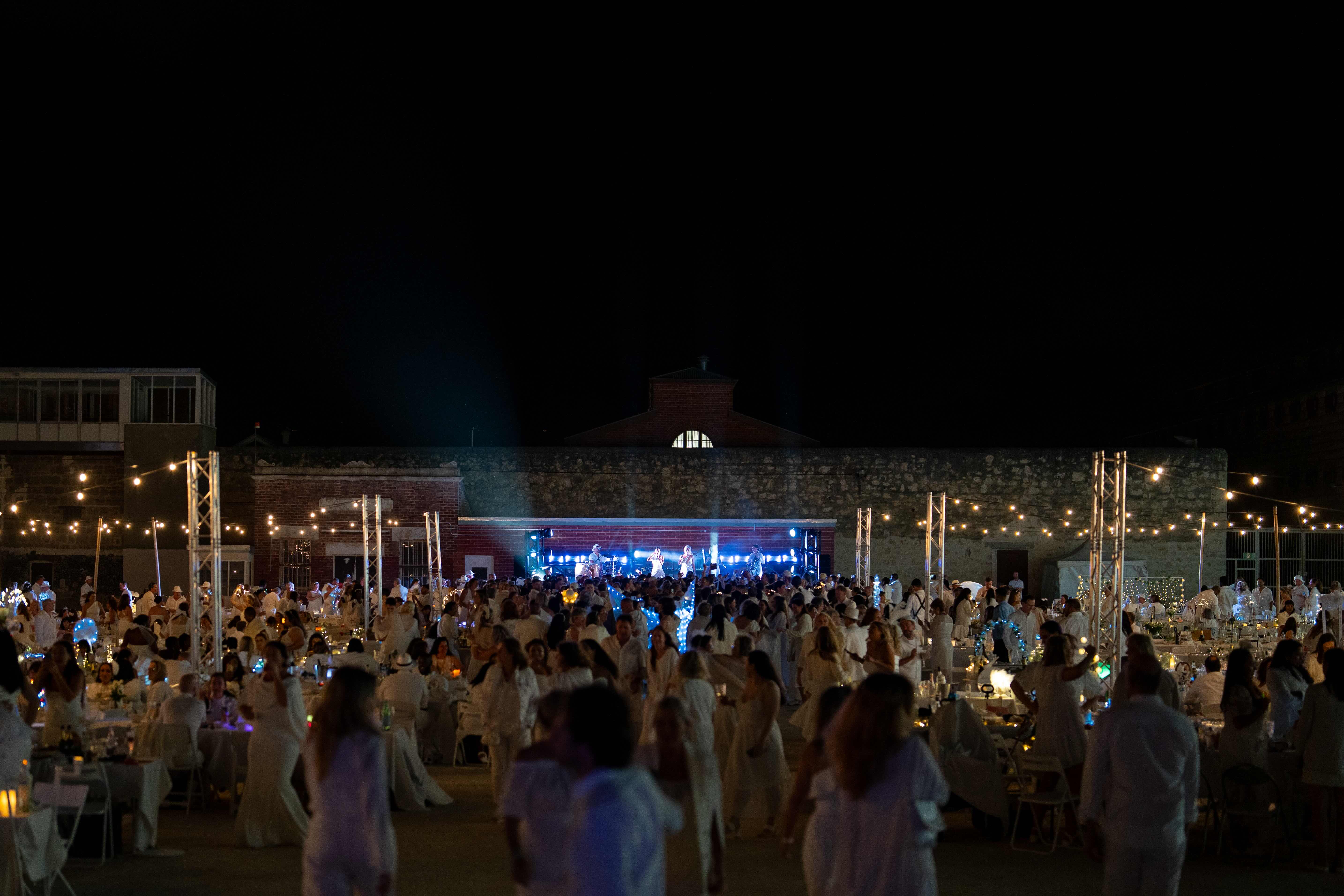 A wide shot of a large crowd at Perth's secret luxury white party, Le Diner en Blanc