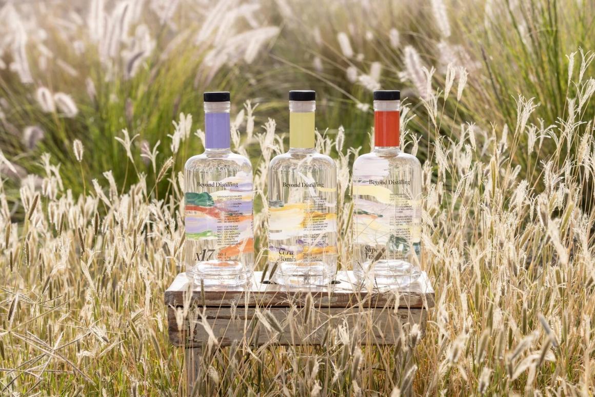 Three of Beyond Distilling's spirits in a field before their pop-up with Spring on Queen