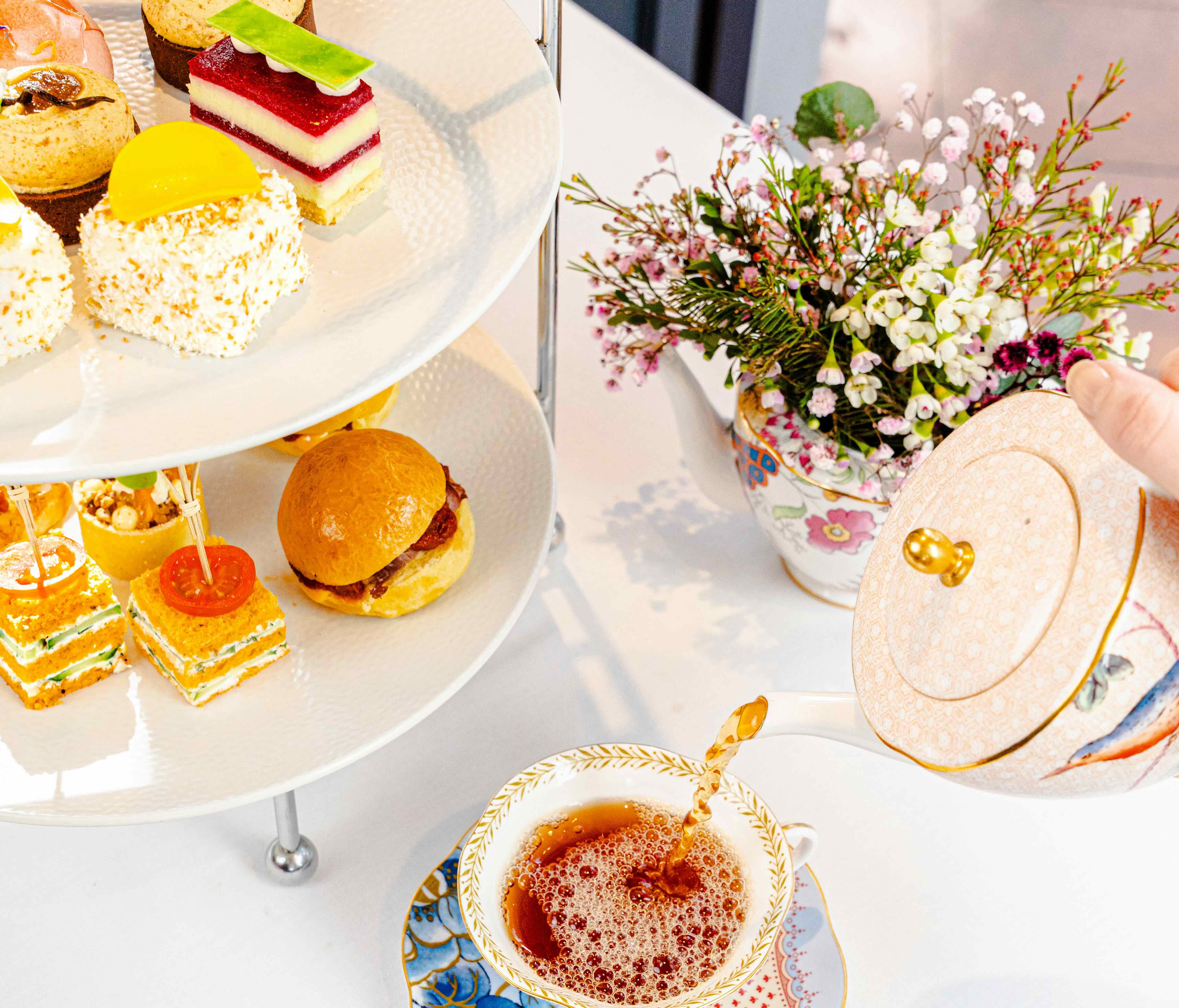 Several food and drink dishes from Pan Pacific Perth's newest high tea for Spring. Including tea being poured.