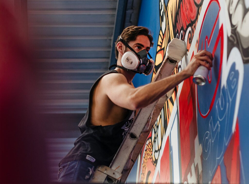 WA Artist Hans Bruechle (aka HANDBRAKE) painting an artwork. His newest exhibition Chaos Concludes will show at Fremantle's naval store in October.