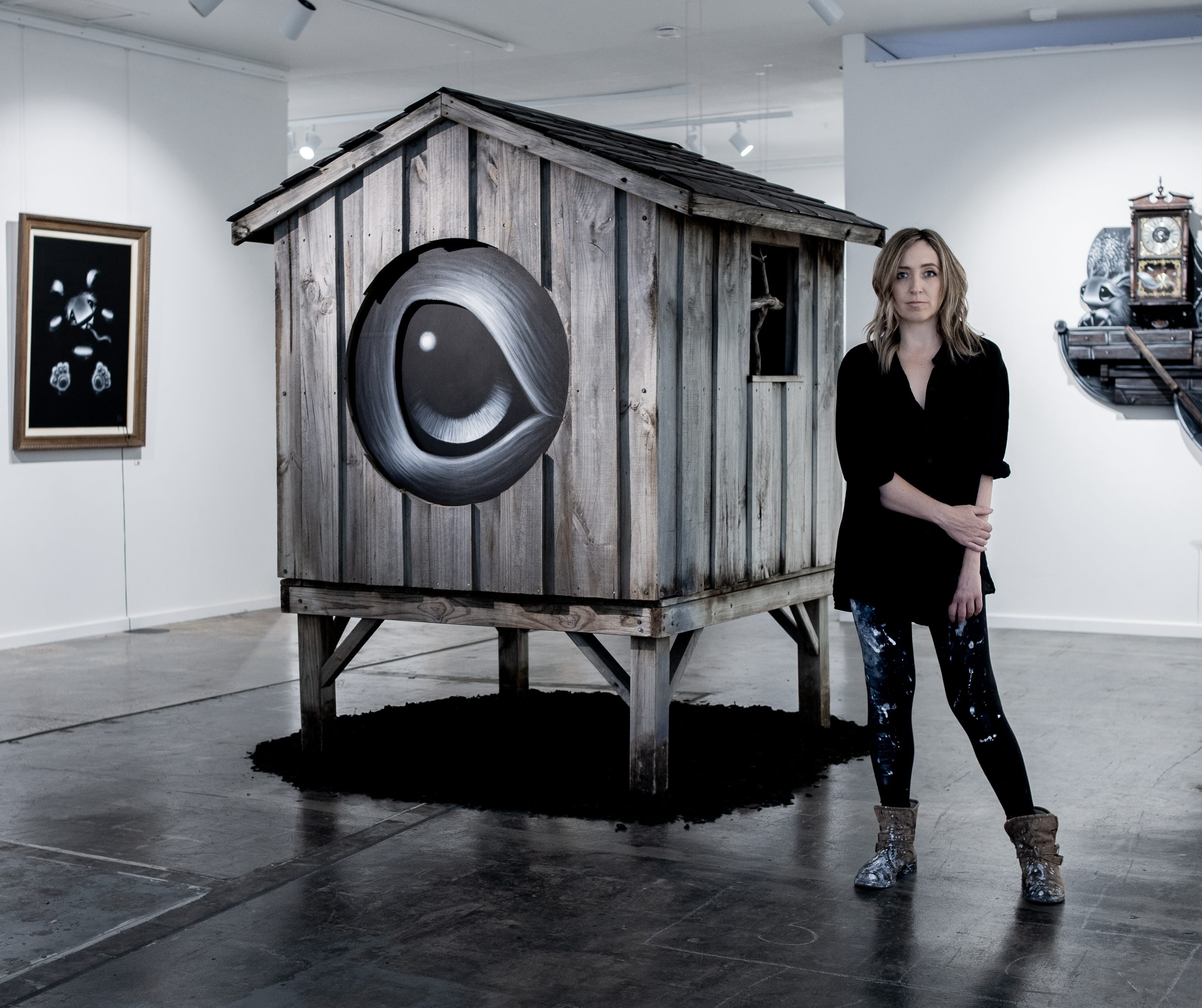 Local street artist in Perth Hayley Welsh stands beside one of her artworks