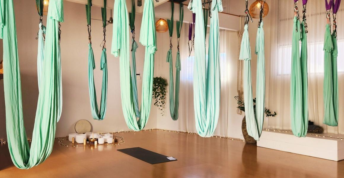 Aerial yoga silks hang from the ceiling at one of the fun exercise classes to try in Perth