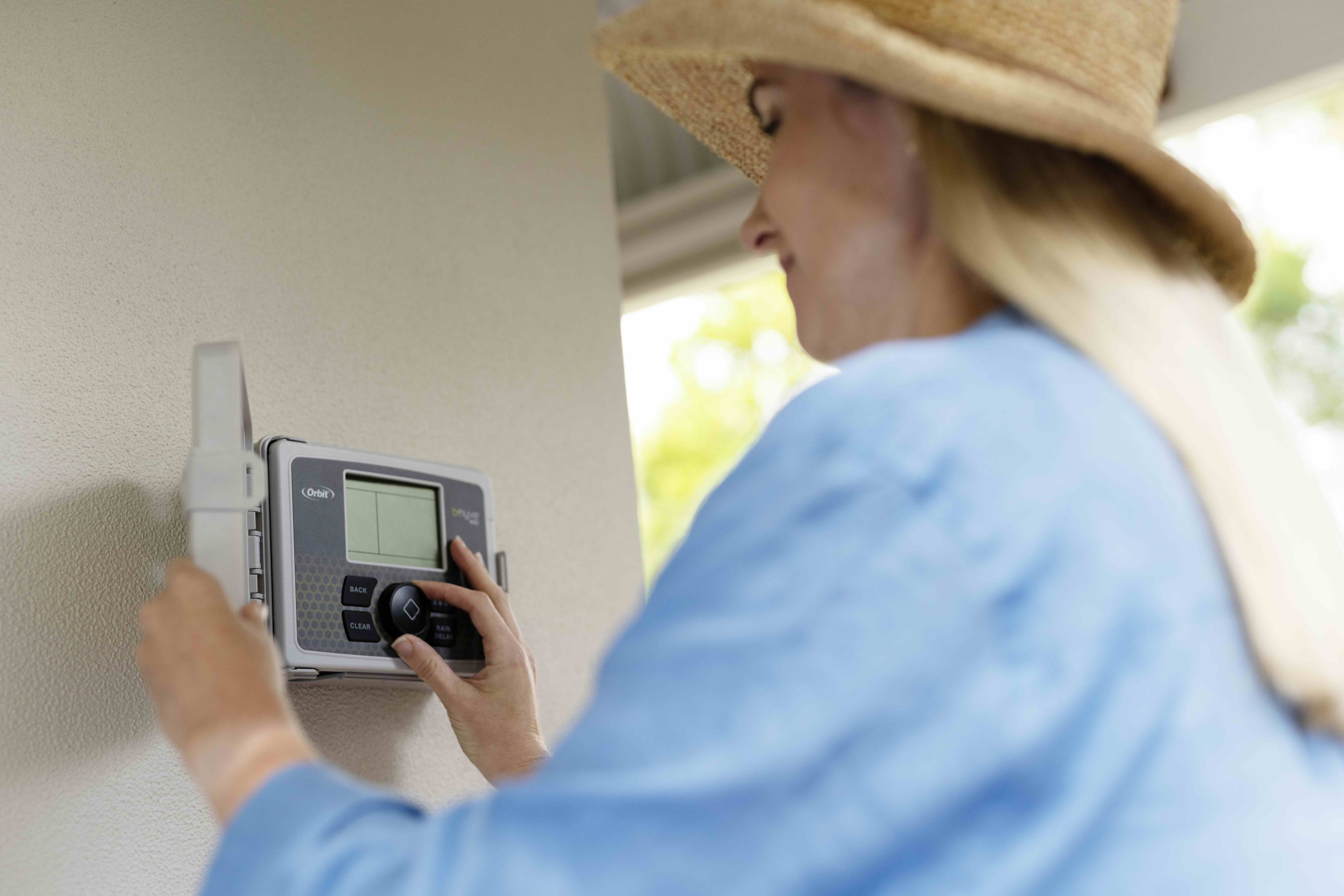 A woman switching off her sprinklers as part of the Winter Sprinkler Switch-off by Water Corporation