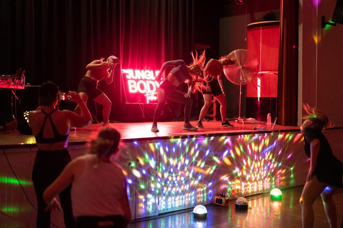 Woman dance on the stage at The Jungle Body Tribe, one of the fun exercise classes to try in Perth