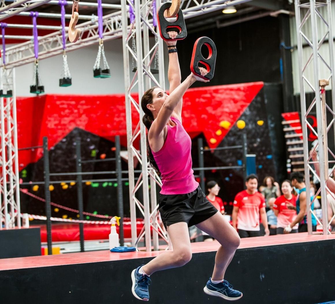 A woman attempting the course at Ninja Academy, one of the fun exercise classes to try in Perth