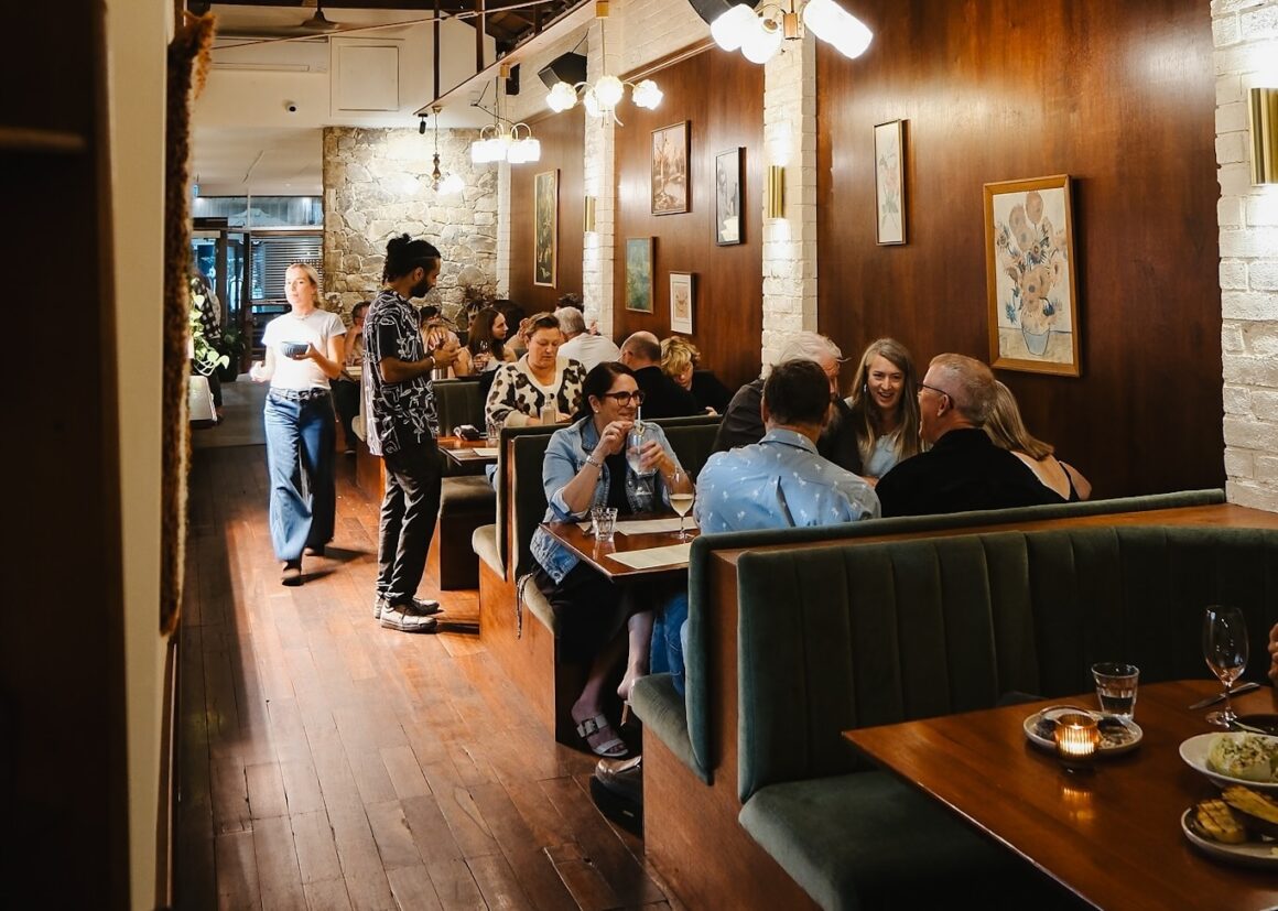 People eating at The Banksia Tavern, A spread of food on the table at INARA, one of the best food spots in Busselton