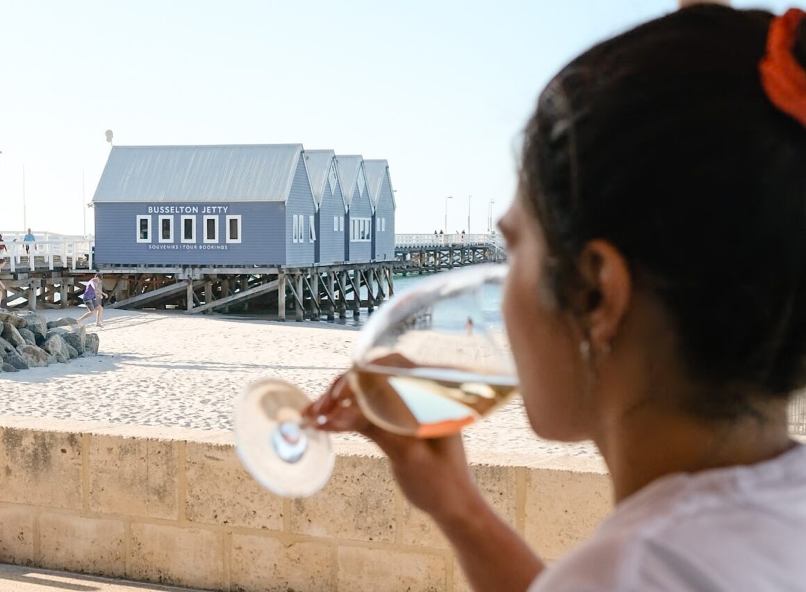 A woman drinking wine at The Goose, A spread of food on the table at INARA, one of the best food spots in Busselton