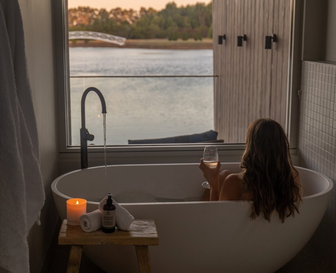 A woman enjoying wine in the bath at Edge Luxury Villas