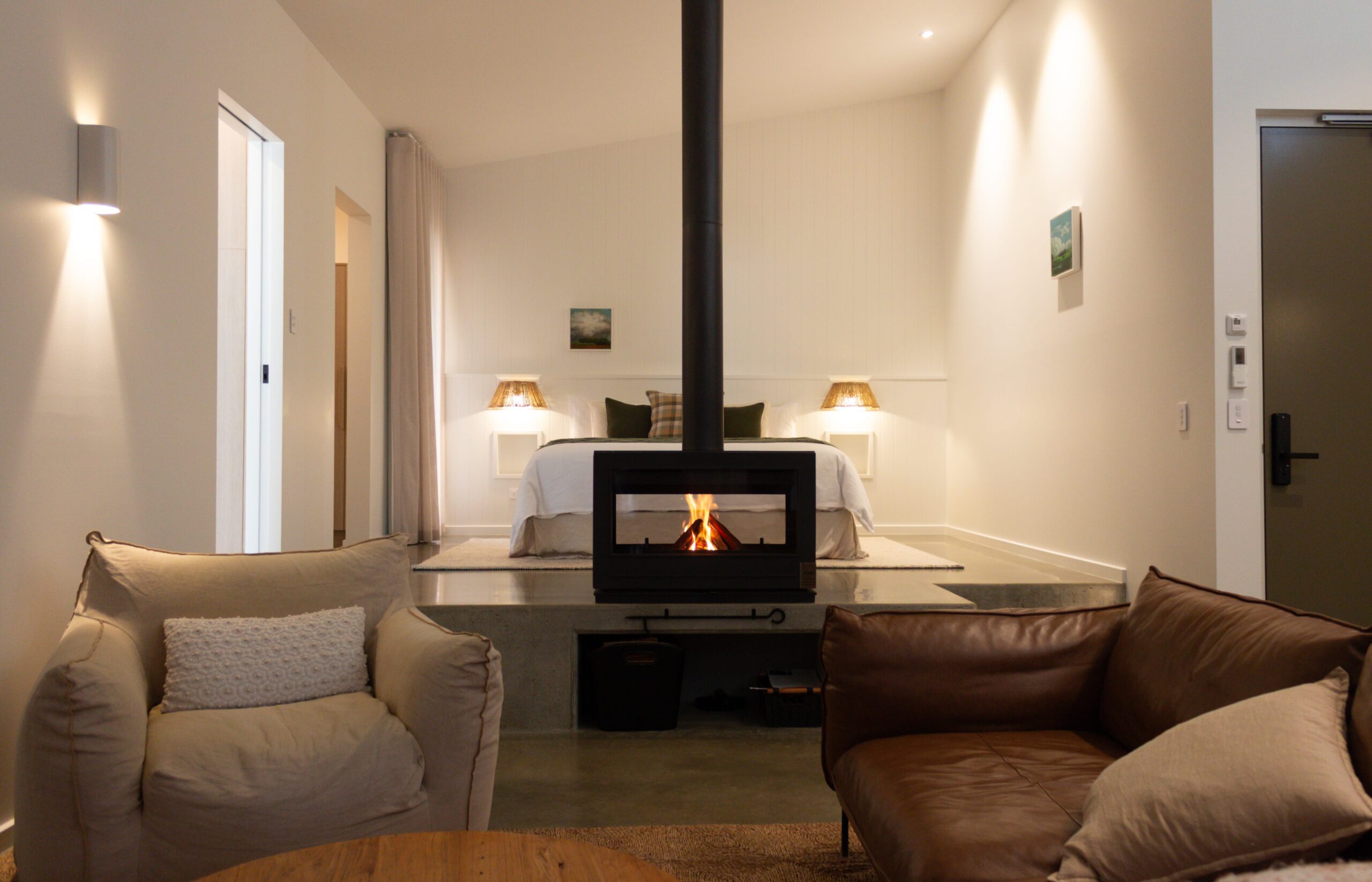 An inside view of the fireplace, lounge and bedroom at Edge Luxury Villas