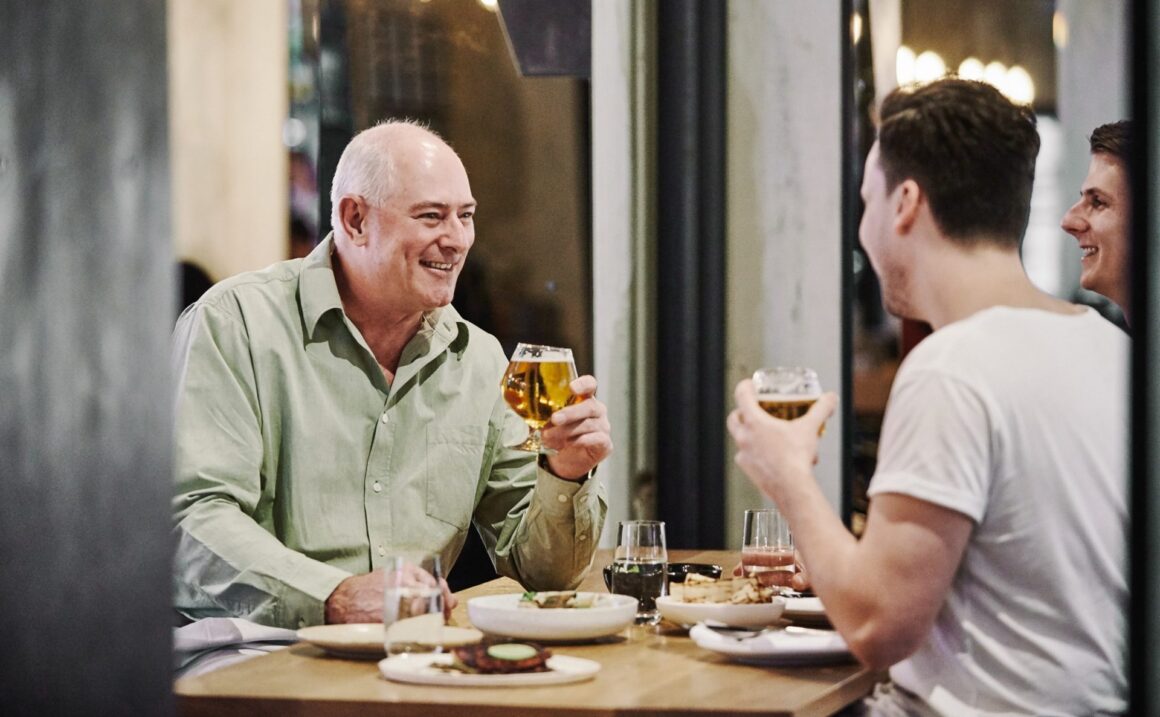 two guys sharing a beer at beer corner, pasta at alba, one of the best activities for Father's Day in Perth