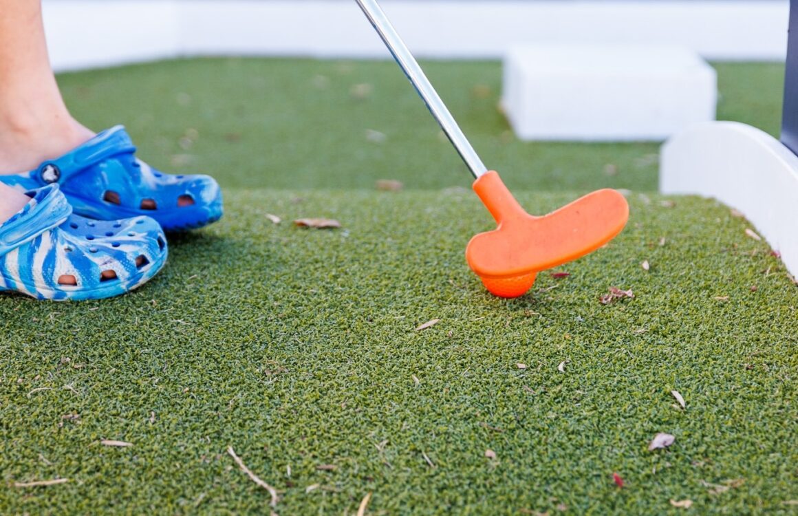 a child playing mini golf at the claremont hotel, pasta at alba, one of the best activities for Father's Day in Perth