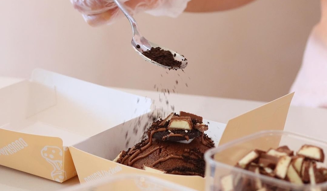 decorating a cookie at Cookie Loaded, one of the best cookie places in Perth