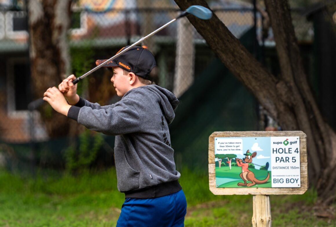 a child playing mini golf at supa golf, pasta at alba, one of the best activities for Father's Day in Perth