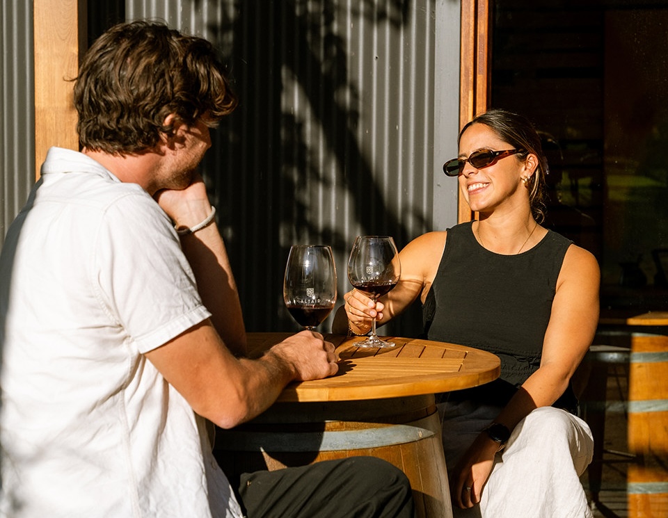 A couple enjoying wine at a winery near Edge Luxury Villas