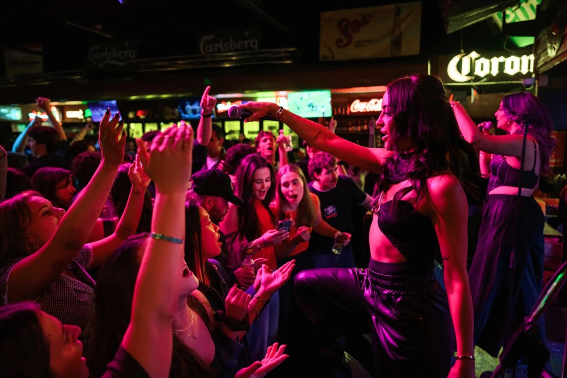 a live band performing at The Mustang Bar for their 27th birthday bash tailgate