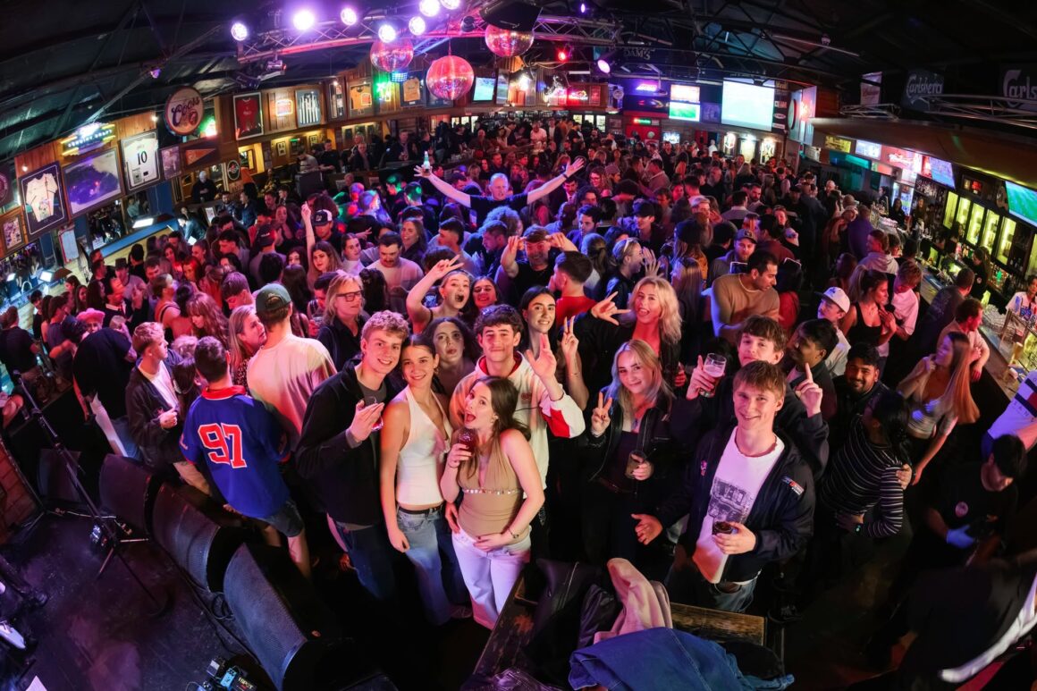 A crowd at The Mustang Bar for their 27th birthday bash tailgate